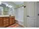 Bright bathroom featuring oak vanity, bathtub, shower combo and decorative butterfly accent at 1155 S Annie Ln, Gilbert, AZ 85296