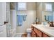 A bathroom features a tub-shower combo and a vanity with drawers and bronze fixtures at 1155 S Annie Ln, Gilbert, AZ 85296