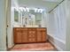 Bathroom with double vanity and shower-tub combo showcasing functionality and design at 1155 S Annie Ln, Gilbert, AZ 85296