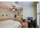 Light and airy bedroom with ceiling fan, cream walls and a large dresser and desk at 1155 S Annie Ln, Gilbert, AZ 85296