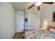 Bright bedroom with a ceiling fan, closet and a view of side table with lamp at 1155 S Annie Ln, Gilbert, AZ 85296