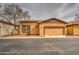 The exterior features stucco and a two-car garage, complemented by a bare tree at 1155 S Annie Ln, Gilbert, AZ 85296