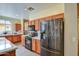 Modern kitchen featuring stainless steel appliances, a breakfast bar, and tile flooring at 1155 S Annie Ln, Gilbert, AZ 85296