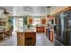 Modern kitchen featuring stainless steel appliances, a breakfast bar, and tile flooring at 1155 S Annie Ln, Gilbert, AZ 85296