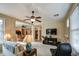 Spacious living room with an open layout, a ceiling fan, and seamless transition to the dining area at 1155 S Annie Ln, Gilbert, AZ 85296