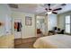 Main bedroom featuring a ceiling fan, carpet, and access to the main bathroom at 1155 S Annie Ln, Gilbert, AZ 85296