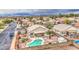 Aerial view of a home featuring a pool, patio area, and desert landscaping in a well-maintained backyard at 12450 W Holly St, Avondale, AZ 85392