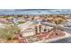 Aerial view of a well-maintained home featuring a tile roof, desert landscaping, and a two-car garage at 12450 W Holly St, Avondale, AZ 85392