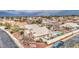 Aerial view of a home with a private backyard oasis featuring a pool, desert landscaping, and a white tiled roof at 12450 W Holly St, Avondale, AZ 85392