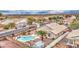 Aerial view of a home featuring desert landscaping, a private pool, and a covered patio area for outdoor living at 12450 W Holly St, Avondale, AZ 85392