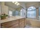 Bathroom featuring a tub, arched window, and a spacious vanity at 12450 W Holly St, Avondale, AZ 85392