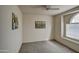 Bright bedroom featuring modern ceiling fan and natural light at 12450 W Holly St, Avondale, AZ 85392