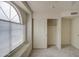 Bedroom featuring a closet with sliding doors and a large window at 12450 W Holly St, Avondale, AZ 85392