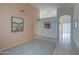 Bright entryway with neutral walls, tile flooring, and decorative wall art, creating a welcoming ambiance at 12450 W Holly St, Avondale, AZ 85392