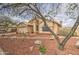 Charming home exterior with desert landscaping, mature trees, and inviting curb appeal at 12450 W Holly St, Avondale, AZ 85392