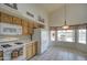 Bright kitchen featuring white appliances and an eat-in area with backyard pool views at 12450 W Holly St, Avondale, AZ 85392