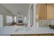 Bright kitchen with stainless steel sink and view of the living area at 12450 W Holly St, Avondale, AZ 85392