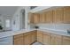 Corner view of kitchen features white countertops and oak wood cabinetry at 12450 W Holly St, Avondale, AZ 85392