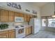 Bright kitchen with wood cabinets, white appliances, and a breakfast nook at 12450 W Holly St, Avondale, AZ 85392