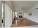 Bright living room features laminate wood flooring, fireplace, and a ceiling fan at 12450 W Holly St, Avondale, AZ 85392