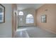 Inviting living room with neutral colors, arched windows, and carpeted and tiled floors at 12450 W Holly St, Avondale, AZ 85392