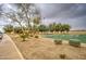 Scenic view of community park featuring a basketball court, trees, and walking paths at 12450 W Holly St, Avondale, AZ 85392