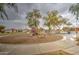 Community playground featuring a slide, swings, and seesaw on a well-maintained sand lot under mature shade trees at 12450 W Holly St, Avondale, AZ 85392