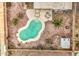 Aerial view of a private backyard pool and landscaped patio with seating area at 12450 W Holly St, Avondale, AZ 85392