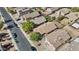 Aerial view of residential homes featuring desert landscaping, tile roofs, solar panels and community pool in the neighborhood at 12454 W Redfield Rd, El Mirage, AZ 85335