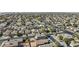 Wide aerial view of a planned community showcasing rows of single-Gathering homes and winding streets and green trees at 12454 W Redfield Rd, El Mirage, AZ 85335