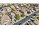 An aerial view of a residential neighborhood featuring Southwestern-style homes with solar panels and desert landscaping at 12454 W Redfield Rd, El Mirage, AZ 85335