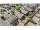 Aerial neighborhood view featuring desert landscaping, tile roofs, backyards, and a mix of one and two story homes at 12454 W Redfield Rd, El Mirage, AZ 85335