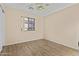 This bedroom features a ceiling fan and new wood-style flooring at 12454 W Redfield Rd, El Mirage, AZ 85335