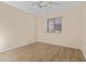 This bedroom features a ceiling fan and new wood-style flooring at 12454 W Redfield Rd, El Mirage, AZ 85335