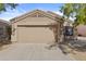 A single-Gathering home featuring a well-maintained yard, driveway, and a two-car garage at 12454 W Redfield Rd, El Mirage, AZ 85335