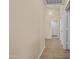 Hallway with wood-look flooring leading to rooms and a door to the exterior of the home at 12454 W Redfield Rd, El Mirage, AZ 85335