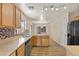 Well-lit kitchen with stainless steel appliances, mosaic tile backsplash, and wood cabinets at 12454 W Redfield Rd, El Mirage, AZ 85335