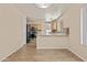 Open kitchen with stainless steel appliances, mosaic backsplash, wood cabinets and light-colored walls at 12454 W Redfield Rd, El Mirage, AZ 85335