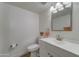 Cozy bathroom featuring white fixtures, a framed mirror, and an updated vanity at 1320 E Bethany Home Rd # 104, Phoenix, AZ 85014