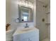 Bright bathroom featuring a modern vanity, framed mirror, and tiled shower with built-in shelving at 1320 E Bethany Home Rd # 104, Phoenix, AZ 85014