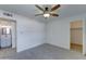 Neutral bedroom features wood-look tile flooring, a ceiling fan, an ensuite bathroom, and a closet at 1320 E Bethany Home Rd # 104, Phoenix, AZ 85014