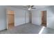 Spacious bedroom showcasing an ensuite bathroom and walk-in closet, complemented by wood-look tile flooring at 1320 E Bethany Home Rd # 104, Phoenix, AZ 85014