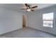 Neutral bedroom showcasing wood-look tile flooring, a ceiling fan, and an open closet at 1320 E Bethany Home Rd # 104, Phoenix, AZ 85014