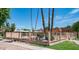 Exterior view of the community pool with landscaping and nearby buildings at 1320 E Bethany Home Rd # 104, Phoenix, AZ 85014