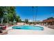 Community pool surrounded by red tables and chairs at 1320 E Bethany Home Rd # 104, Phoenix, AZ 85014