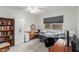 Carpeted bedroom with a dresser, desk, shelving and a bright window at 14013 N Boswell Blvd, Sun City, AZ 85351