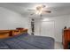 Carpeted bedroom features large closet, headboard with shelves and ceiling fan at 14013 N Boswell Blvd, Sun City, AZ 85351