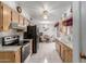 Kitchen with black appliances, cabinets, tiled floor, and view of dining area at 14013 N Boswell Blvd, Sun City, AZ 85351