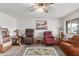 Cozy living room with carpet, ceiling fan, and eclectic decor featuring recliner seating at 14013 N Boswell Blvd, Sun City, AZ 85351