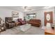 Cozy living room with carpet flooring, ceiling fan, and front-facing window at 14013 N Boswell Blvd, Sun City, AZ 85351